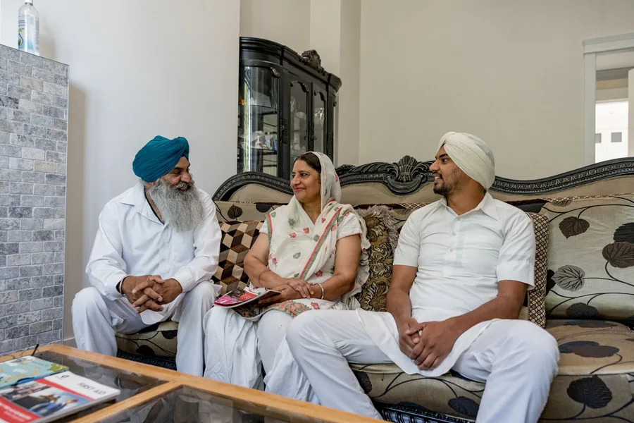 Family photographed together at home in their own drawing room