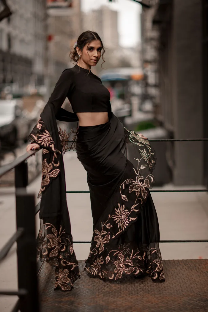 Matrimonial portrait in a black saree photographed against the light