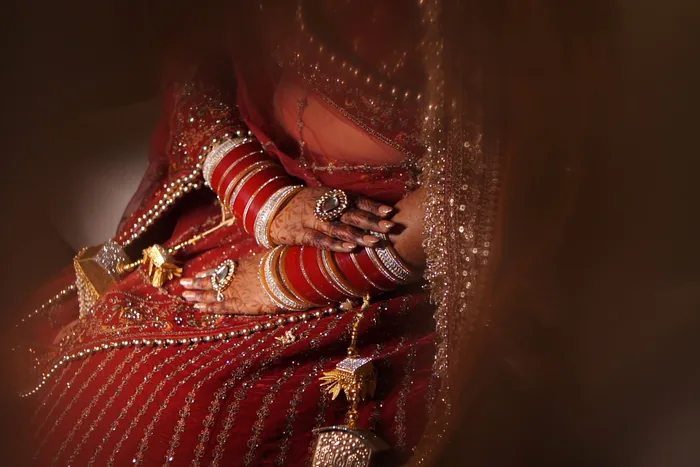 The bride's red chooda in soft focus