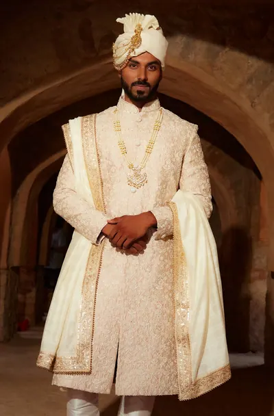 Close view of the groom's sherwani with the pearl mala and brooch